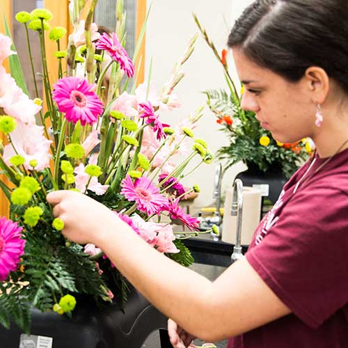 student with bouquet of flowers