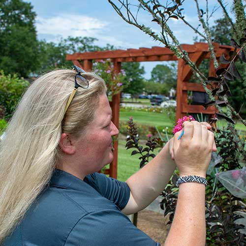 student working with flowers