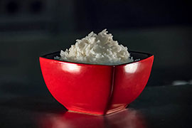 red bowl of rice on black background