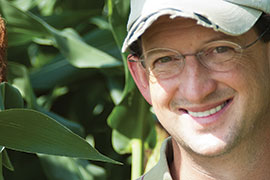 scientist in front of corn field